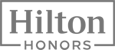 The image shows a logo with the text "Hilton Honors" in a rectangular frame.